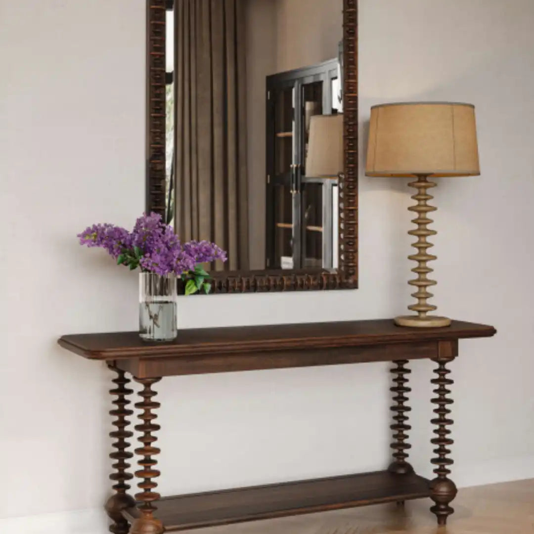 Dark wood console table with unique turned legs, featuring a lower shelf.