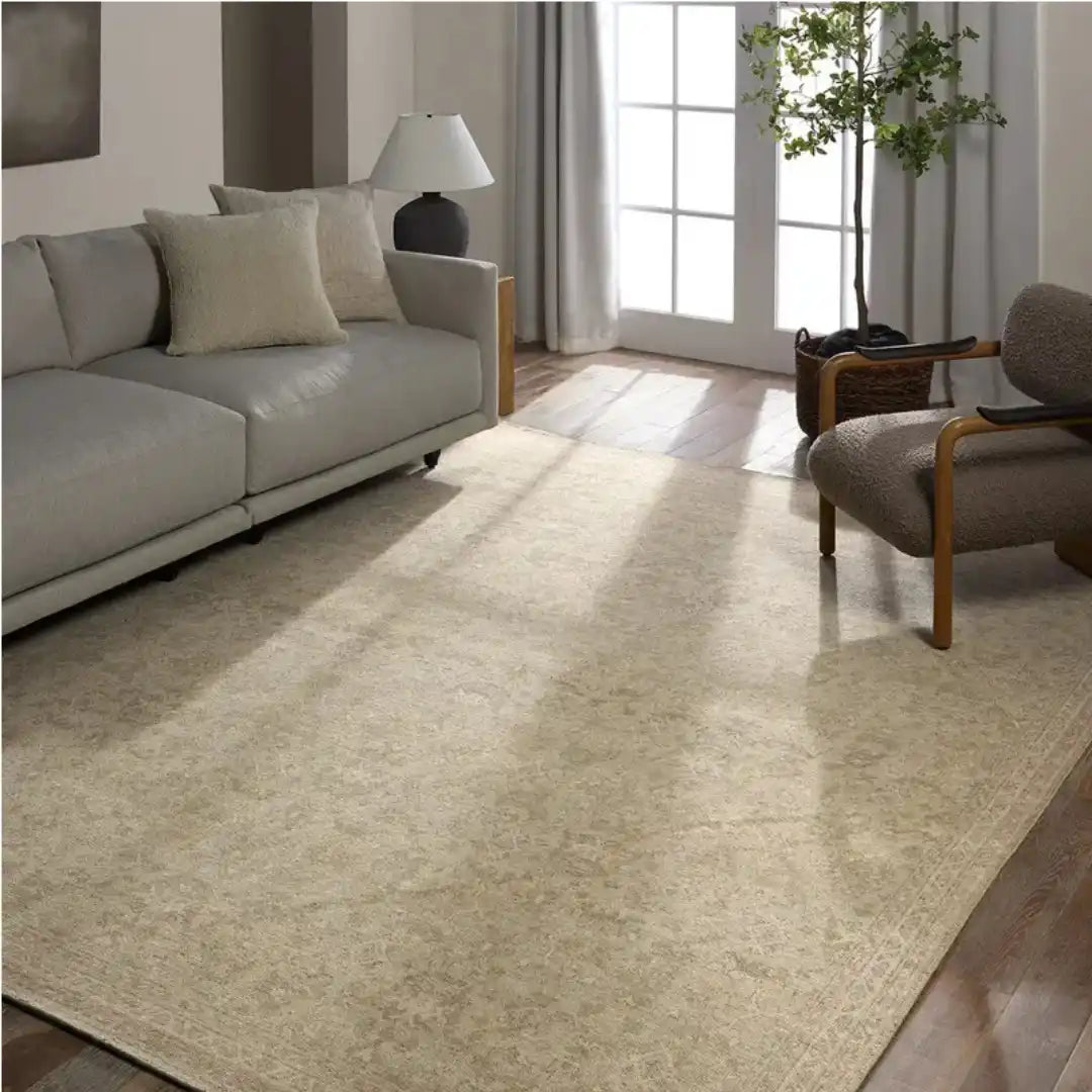 A rectangular, light-colored rug with subtle, traditional patterns.
